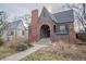 Charming brick home with a barrel arch entryway, chimney and gabled roof at 265 S Pennsylvania St, Denver, CO 80209