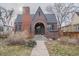 Charming brick home featuring a barrel arch entryway and gabled roof at 265 S Pennsylvania St, Denver, CO 80209