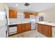 Kitchen with wood cabinets, white appliances and hardwood floors at 265 S Pennsylvania St, Denver, CO 80209