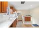 Kitchen with wood cabinets, white appliances and hardwood floors at 265 S Pennsylvania St, Denver, CO 80209