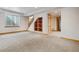 Finished basement area featuring carpet, a window, and built-in shelves at 2626 Tamarac St, Denver, CO 80238