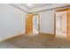 Bright bedroom with a glimpse into the tiled bathroom and a carpeted floor at 2626 Tamarac St, Denver, CO 80238