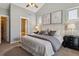 This cozy bedroom features neutral walls, carpet flooring, and a ceiling fan for added comfort at 2626 Tamarac St, Denver, CO 80238