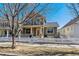 Two-story house with inviting front porch and a playful swing set at 2626 Tamarac St, Denver, CO 80238