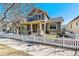 Charming two-story home with a welcoming front porch and white picket fence at 2626 Tamarac St, Denver, CO 80238