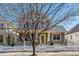 Two-story home featuring a cozy front porch and a well-maintained lawn at 2626 Tamarac St, Denver, CO 80238