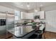 Modern kitchen with granite countertops, stainless steel appliances, and a breakfast bar at 2626 Tamarac St, Denver, CO 80238