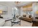 Bright living room featuring large windows and an open archway at 2626 Tamarac St, Denver, CO 80238