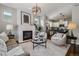 Comfortable living room featuring a fireplace, stylish decor, and seamless kitchen access at 2626 Tamarac St, Denver, CO 80238