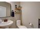 Clean and well-maintained powder room with pedestal sink and decorative shelving at 15869 E Otero Ave, Centennial, CO 80112