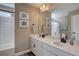 Bright bathroom with double sink vanity, framed mirrors, and a shower-tub combination with white tile surround at 15869 E Otero Ave, Centennial, CO 80112