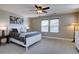 Bedroom featuring a white bed frame, ceiling fan, and three landscape prints on the wall at 15869 E Otero Ave, Centennial, CO 80112