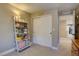 Well-lit bedroom features neutral walls, closet with sliding doors, and ladder shelf for storage and decor at 15869 E Otero Ave, Centennial, CO 80112