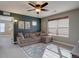 Bonus room with cozy brown sectional couch, ceiling fan, and natural window shade at 15869 E Otero Ave, Centennial, CO 80112