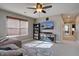 Bonus room featuring a sectional couch, ceiling fan, and a display cabinet at 15869 E Otero Ave, Centennial, CO 80112