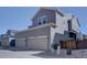 Exterior view of a two-story home with a two-car garage and well-maintained landscaping at 15869 E Otero Ave, Centennial, CO 80112