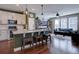 Well-lit kitchen open to living area, featuring granite counters and stainless appliances at 15869 E Otero Ave, Centennial, CO 80112