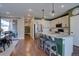 An open concept kitchen and dining area with modern appliances and a granite island at 15869 E Otero Ave, Centennial, CO 80112