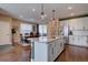 Bright kitchen with granite island and stainless steel appliances overlooking the dining area at 15869 E Otero Ave, Centennial, CO 80112