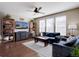 Cozy living room with hardwood floors, ceiling fan, and natural light from large windows at 15869 E Otero Ave, Centennial, CO 80112