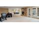 Expansive basement featuring a stone fireplace, billiards table, and walkout access to the outdoors at 67 Indigo Way, Castle Rock, CO 80108