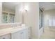 Bright bathroom featuring stone countertops, modern fixtures, ample storage and glass enclosed shower at 67 Indigo Way, Castle Rock, CO 80108