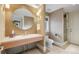 Modern bathroom features a stylish round mirror, floating vanity, and glass-enclosed shower at 67 Indigo Way, Castle Rock, CO 80108
