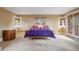 Bedroom featuring french doors, a balcony, carpet, and large windows at 67 Indigo Way, Castle Rock, CO 80108