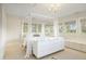 Bright bedroom featuring a unique bed frame, chandelier, built-in storage and many windows at 67 Indigo Way, Castle Rock, CO 80108