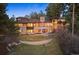 A stately home with an expansive lawn, large windows, stone accents, and lush landscaping at 67 Indigo Way, Castle Rock, CO 80108