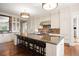 Bright kitchen featuring custom cabinetry, stainless appliances, and a large center island with seating at 67 Indigo Way, Castle Rock, CO 80108