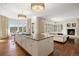 Open-concept kitchen with hardwood floors, island seating, and views of the living area at 67 Indigo Way, Castle Rock, CO 80108