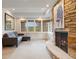 Inviting living room with stone fireplace, stylish seating, and views of the outdoors at 67 Indigo Way, Castle Rock, CO 80108