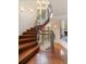 Elegant wooden spiral staircase with iron railings, illuminated by natural light from nearby windows at 67 Indigo Way, Castle Rock, CO 80108