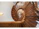 Striking wooden spiral staircase with sleek metal railings, offering a unique design element at 67 Indigo Way, Castle Rock, CO 80108