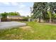 Expansive backyard featuring lush green grass, mature trees, a wooden fence, and a storage shed at 5740 S Cherokee St, Littleton, CO 80120