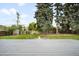 Landscaped backyard with a spacious deck, mature trees, a wooden fence, and a storage shed at 5740 S Cherokee St, Littleton, CO 80120