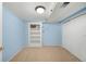 Finished basement featuring light blue walls, a built-in shelving unit, and a spacious closet with sliding doors at 5740 S Cherokee St, Littleton, CO 80120