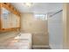 Basement bathroom featuring a shower, tile floor, and ample vanity storage at 5740 S Cherokee St, Littleton, CO 80120