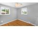 Cozy bedroom with hardwood floors, bright natural light, and white trim, offering a comfortable and inviting space at 5740 S Cherokee St, Littleton, CO 80120