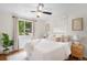 Inviting bedroom with a large window, hardwood floors, neutral decor, and a ceiling fan for added comfort at 5740 S Cherokee St, Littleton, CO 80120