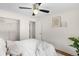 Bright bedroom featuring a ceiling fan, walk-in closet, neutral paint, and modern decor for a relaxing atmosphere at 5740 S Cherokee St, Littleton, CO 80120
