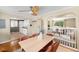 Bright dining area with a wooden table for six, flowing into the living room and adjacent kitchen at 5740 S Cherokee St, Littleton, CO 80120