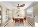 Cozy dining room featuring a modern ceiling fan, decorative wall shelves, and seating for four at 5740 S Cherokee St, Littleton, CO 80120