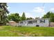 Charming one-story home with grey brick exterior, white trim, dark shutters, and a well-maintained lawn at 5740 S Cherokee St, Littleton, CO 80120