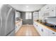Functional kitchen with white cabinetry, stainless steel appliances, and tile flooring for easy maintenance at 5740 S Cherokee St, Littleton, CO 80120