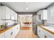 Efficient kitchen layout with white cabinets, stainless steel fridge, and easy access to dining area at 5740 S Cherokee St, Littleton, CO 80120