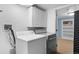 Well-lit laundry room with white cabinets, washer, and dryer, conveniently located near an additional closet space at 5740 S Cherokee St, Littleton, CO 80120
