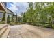 View of a backyard area with trees and a wooden fence at 15705 Red Deer Dr, Morrison, CO 80465
