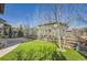 A well-maintained backyard features a grassy area, a wooden fence, and a play set at 15705 Red Deer Dr, Morrison, CO 80465